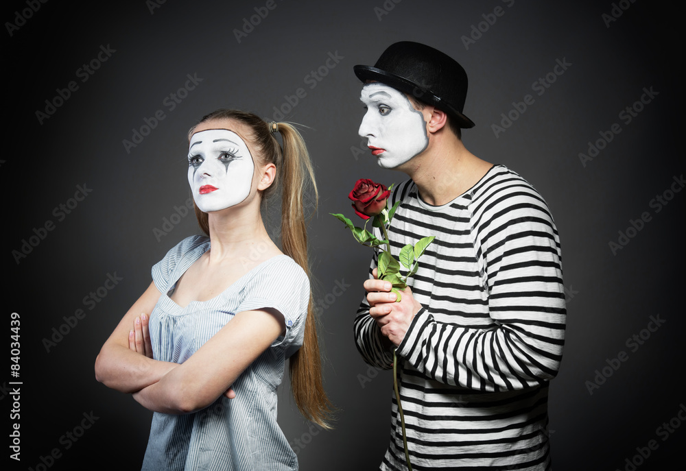 Male mime giving a flower to female mime Male mime giving a flower to female mime