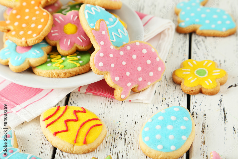 Naklejka premium Colorful easter cookies on white wooden background