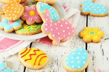 Colorful easter cookies on white wooden background