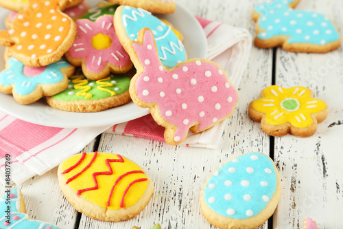 Colorful easter cookies on white wooden background