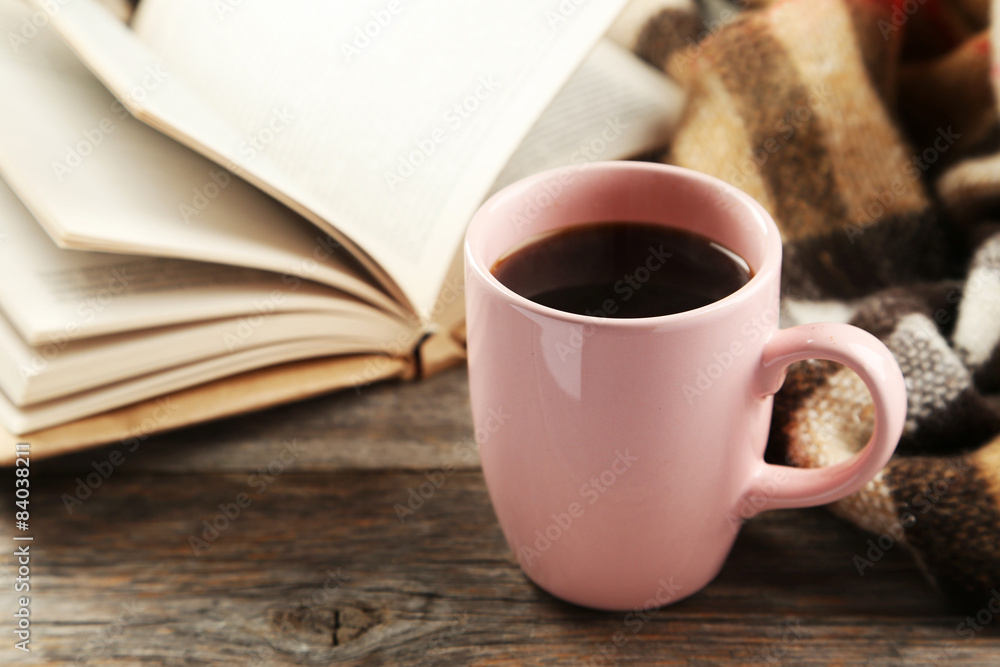 Cup of coffee with plaid and book on grey wooden background Cup of coffee with plaid and book on grey wooden background