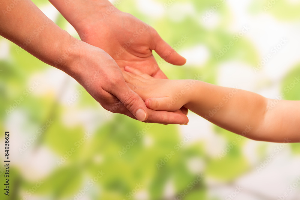 Male hand holding child