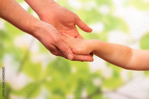 Male hand holding child © laboko