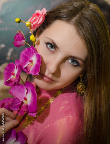 Beautiful girl holding a pink flower