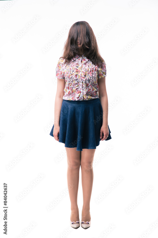 Woman standing with closed face by her hair Woman standing with closed face by her hair