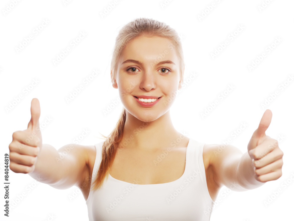 Happy smiling young woman with thumbs up gesture Happy smiling young woman with thumbs up gesture