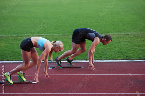 athlete woman group running on athletics race track