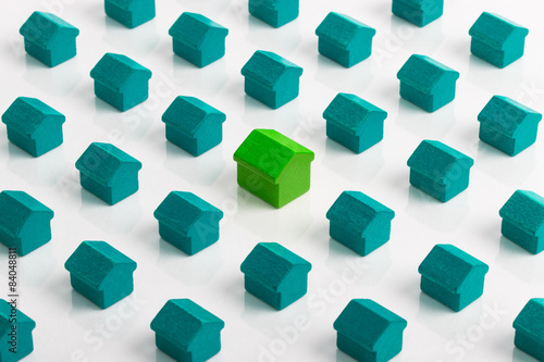 Large green house in group of smaller green turquoise houses.