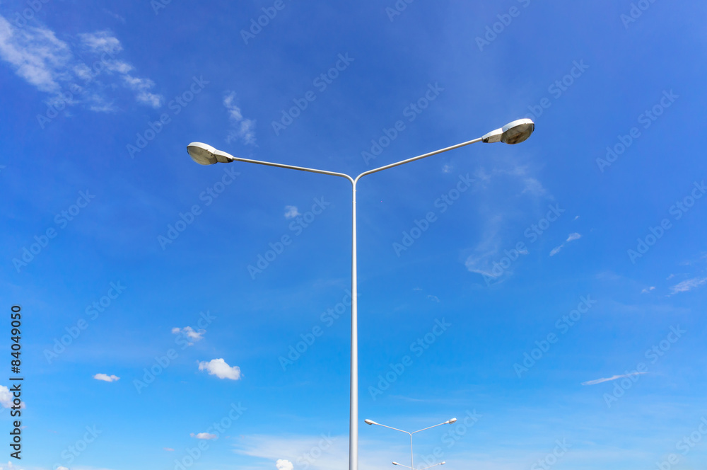 street lamps aligned with blue sky in background street lamps aligned with blue sky in background
