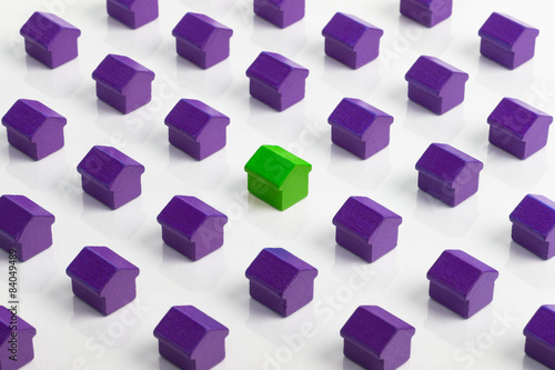 Fotografie Red house in group of purple houses.