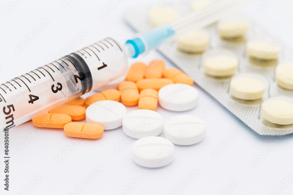Medication in tablets and capsules and insulin syringe Medication in tablets and capsules and insulin syringe