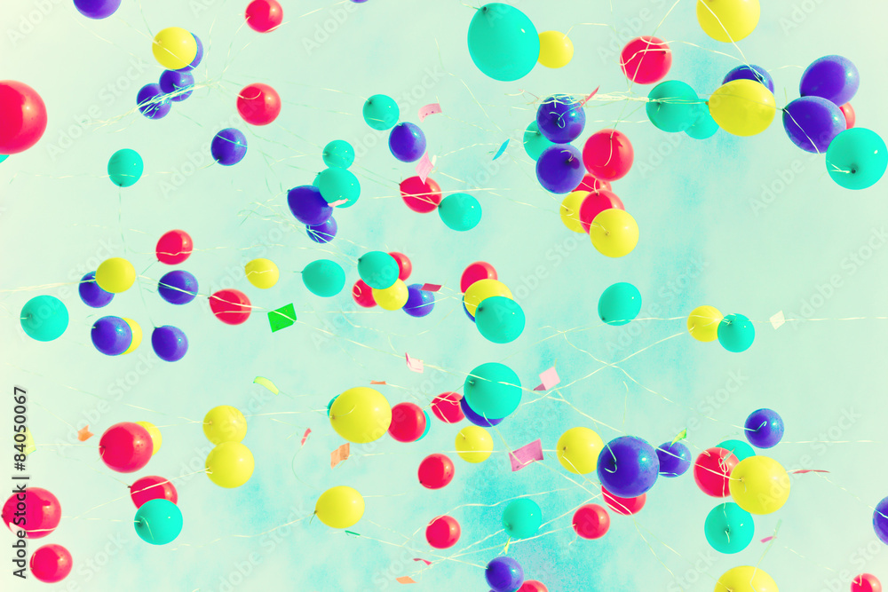 A lot of balloons over a retro sky