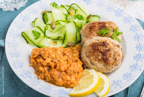 Delicious fried beef meatball, lentils and salad with fresh cucumber