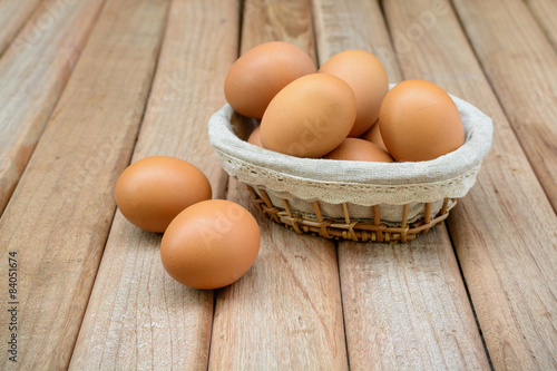 eggs in basket on wooden background