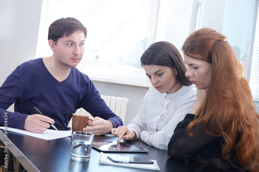 Fototapeta premium Three businessmen discussing something together