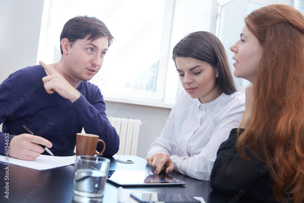 Fototapeta premium Three businessmen discussing something together