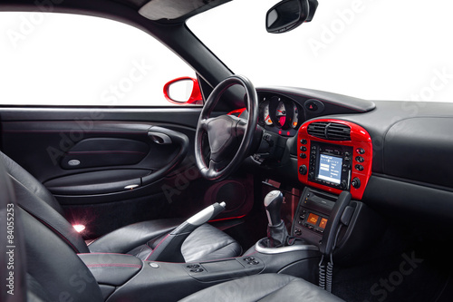 Sport car steering wheel with red dashboard and phone