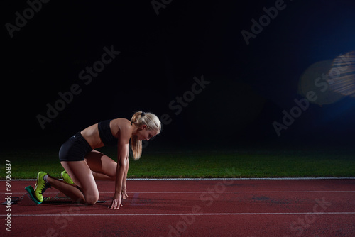 woman sprinter leaving starting blocks