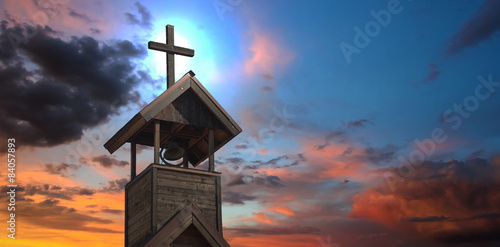 Tablou pe pânză A Bell Tower with Cross at Sunset