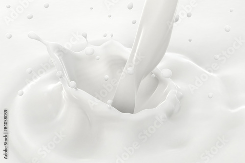 Pouring milk splash and drops with ripples, close-up view.