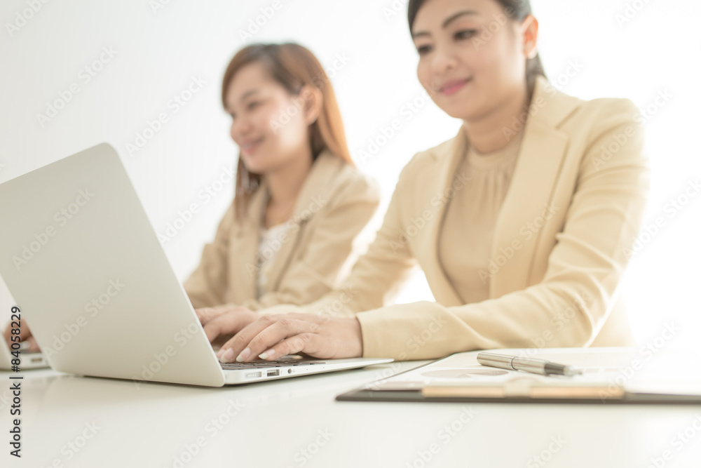 Two Pretty Smiling Businesswomen Discussing Two Pretty Smiling Businesswomen Discussing