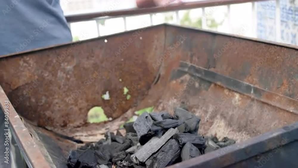 Man preparing charcoal for a BBQ Man preparing charcoal for a BBQ