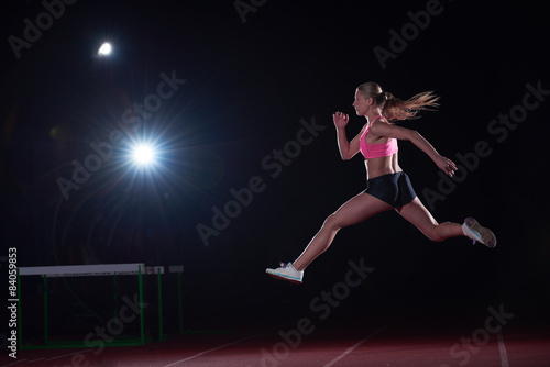 Athletic woman running on track