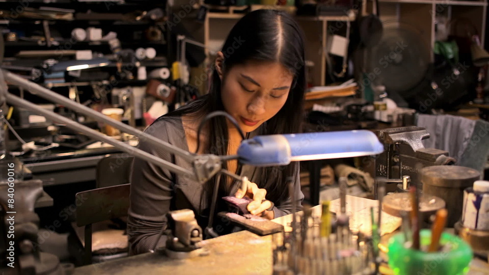 A young woman is doing arts and crafts in an old workshop A young woman is doing arts and crafts in an old workshop