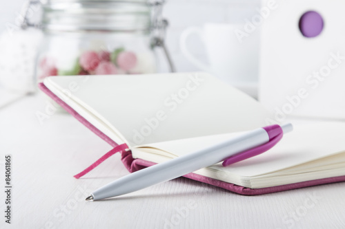 pink ball pen with pink notebook