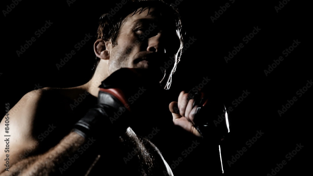 Fighter puts in his mouth piece and clenches his fists, showing he is ready Fighter puts in his mouth piece and clenches his fists, showing he is ready