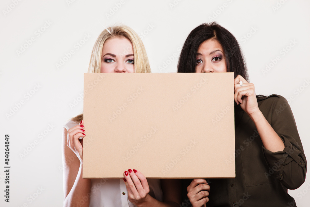 two women holding blank board two women holding blank board