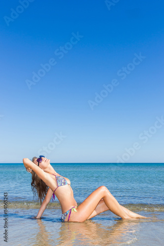happy sexy girl in bikini posing at the beach