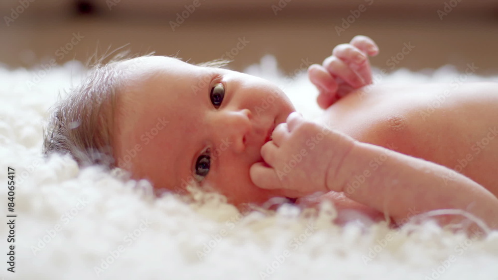 Close up of newborn baby laying on carpet Close up of newborn baby laying on carpet