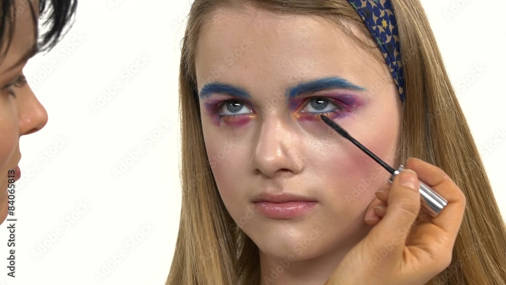 Eye make-up woman applying eyeshadow, making exotic, one, blue Eye make-up woman applying eyeshadow, making exotic, one, blue