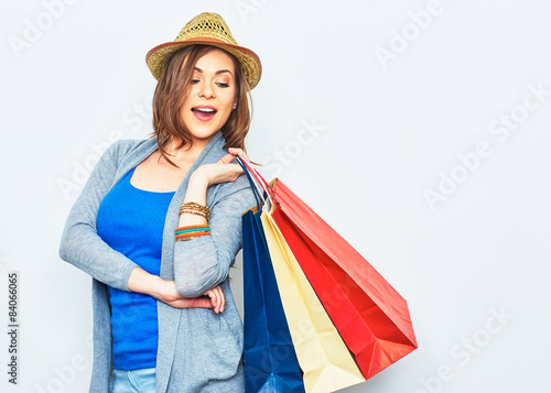 shopping woman holding bags, looking behind.