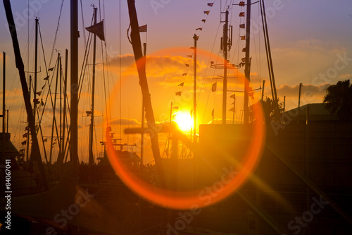 Late sundown at marina with silhouettes and flare effect