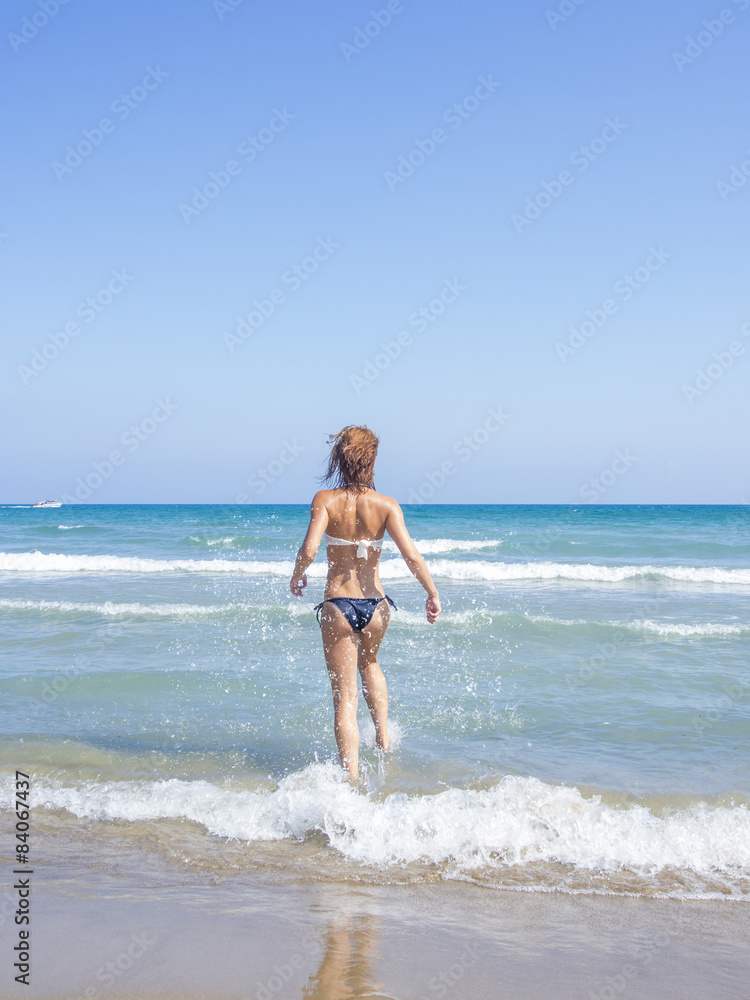 Fototapeta premium Woman on the beach in Kuta Bali