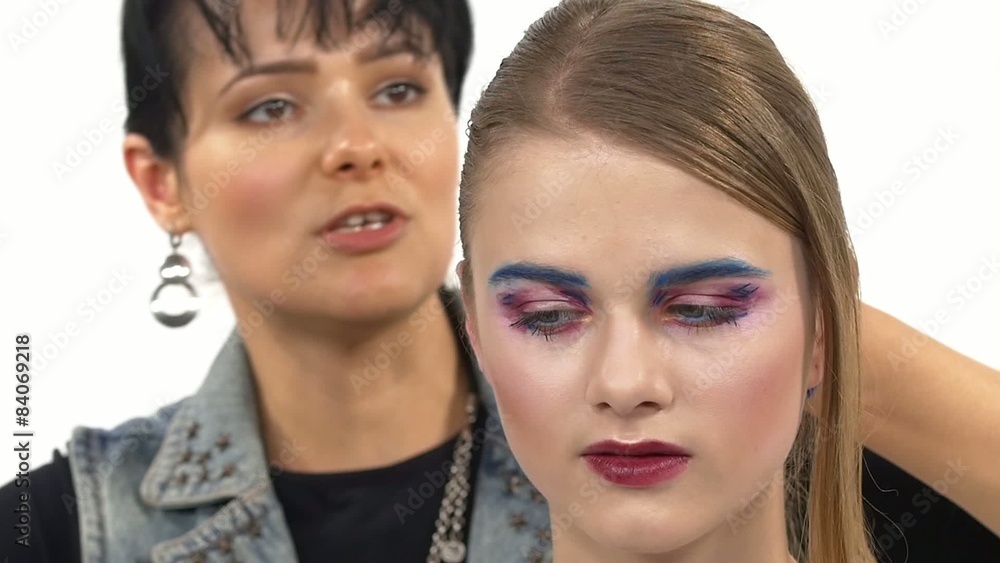 Young beautiful girl applying exotic make up by makeup artist Young beautiful girl applying exotic make up by makeup artist