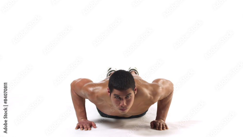 Wide shot of an athletic ethnic man doing push ups
