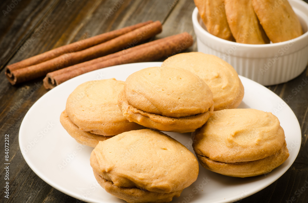 Homemade cookies on white plate and wooden background Homemade cookies on white plate and wooden background