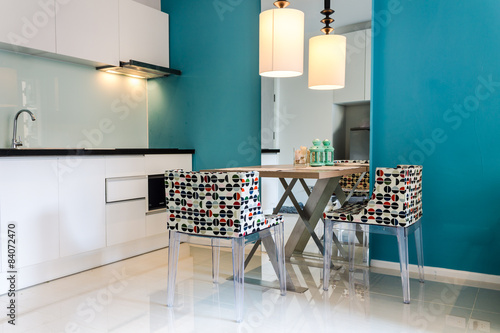 Modern small kitchen interior. / Contemporary mini kitchen with table sets.