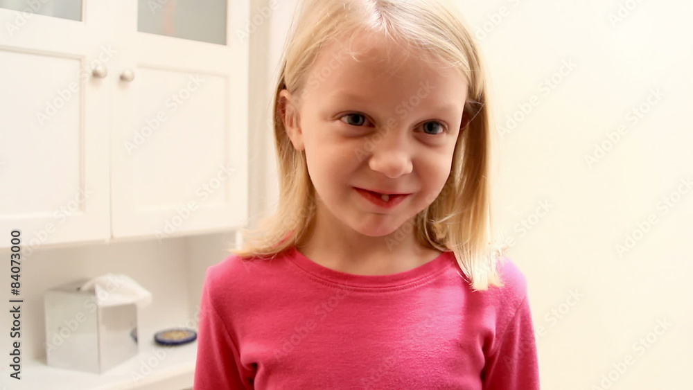 Young girl shows the camera her really loose tooth Young girl shows the camera her really loose tooth