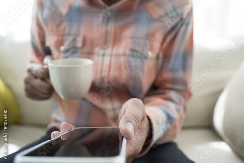 Men have a smart phone while drinking coffee