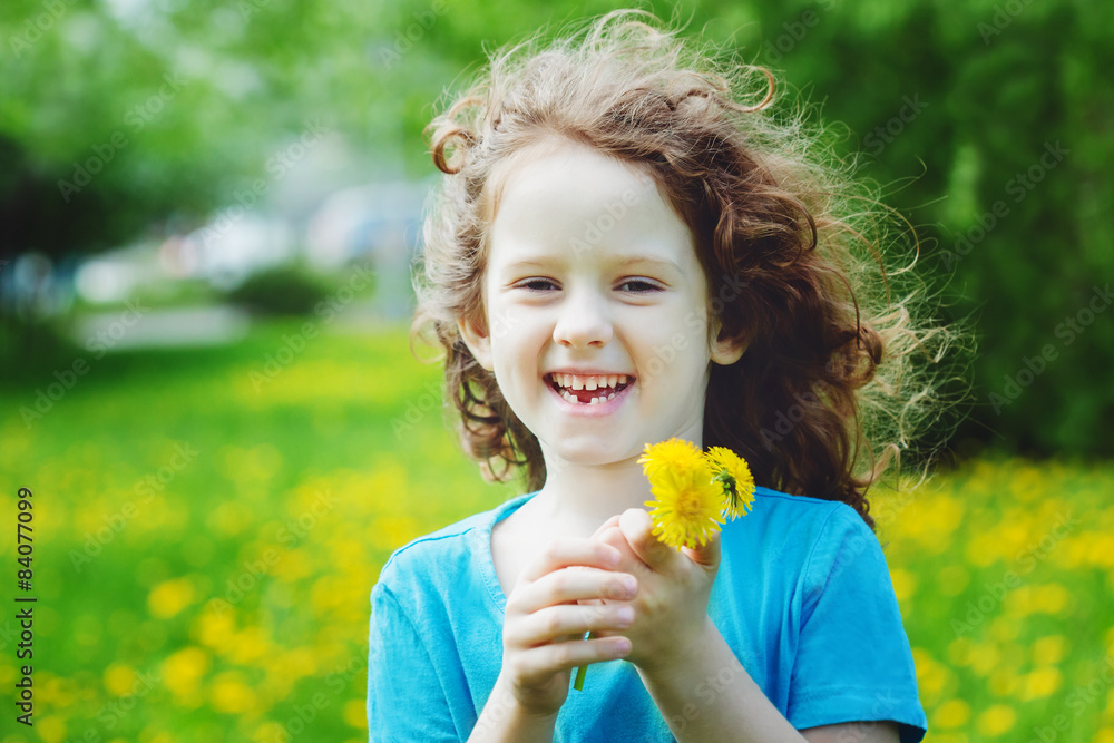 Cute little girl with yellow dandelions in the field. Cute little girl with yellow dandelions in the field.