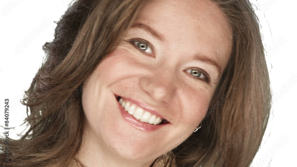 Woman smiles into the camera on a white background Woman smiles into the camera on a white background