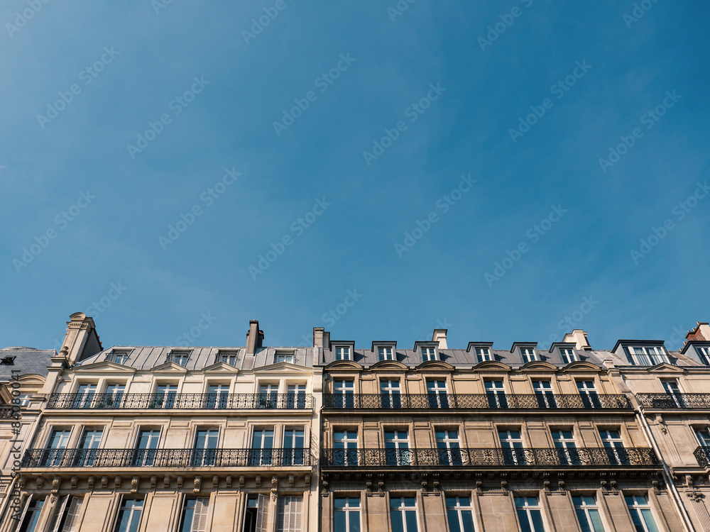 Typical houses in Paris against cloudy sky.