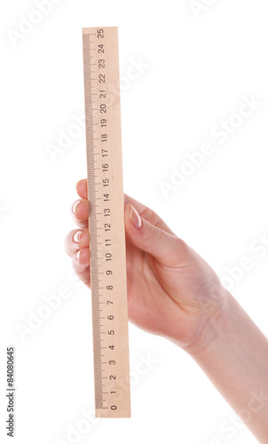 Female hand with wooden ruler isolated on white