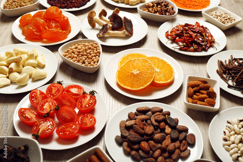 Different products on saucers on wooden table, closeup Different products on saucers on wooden table, closeup