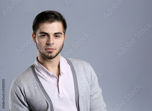 Portrait of young man on gray background © Africa Studio