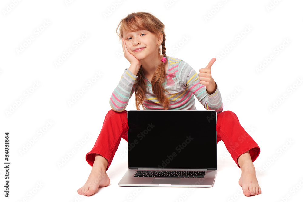 Little girl sitting on floor showing laptop screen Little girl sitting on floor showing laptop screen